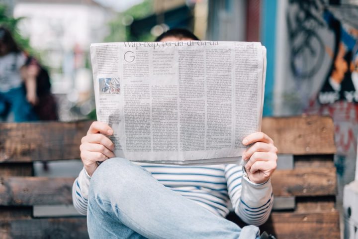 The difference between digital and traditional marketing reading newspaper image